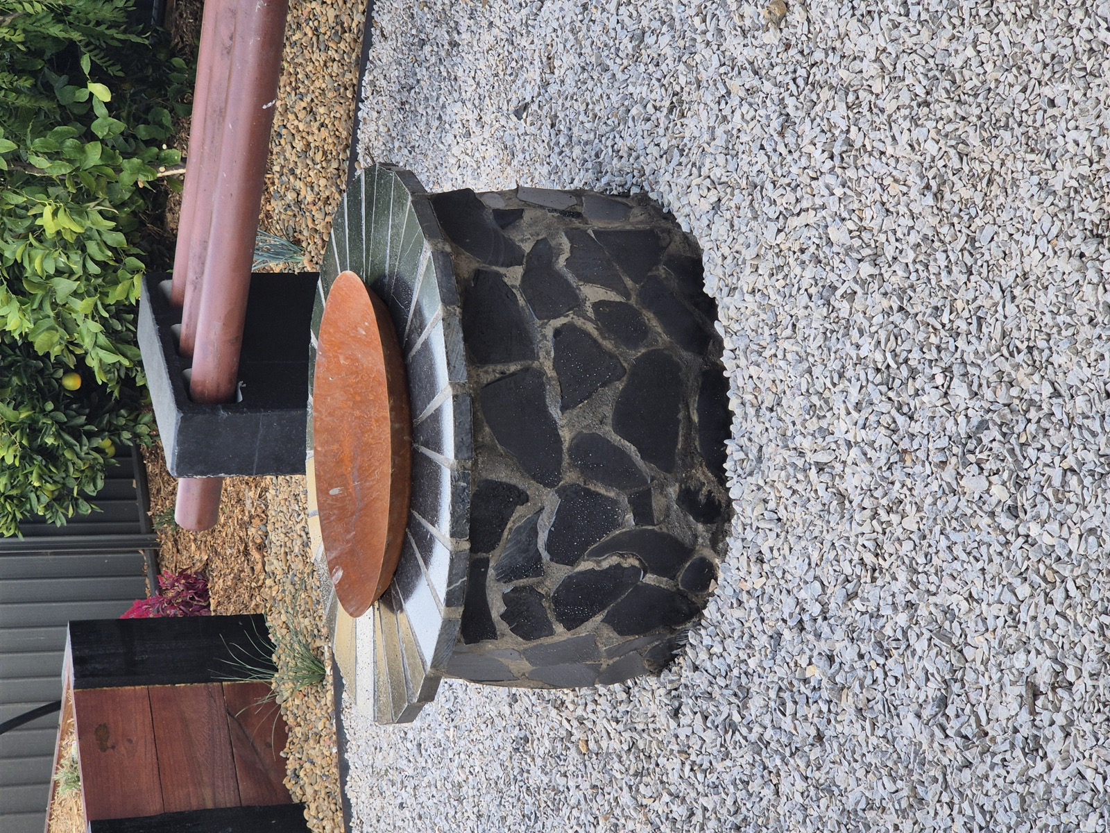 A stone firepit feature built by MR Landscapes