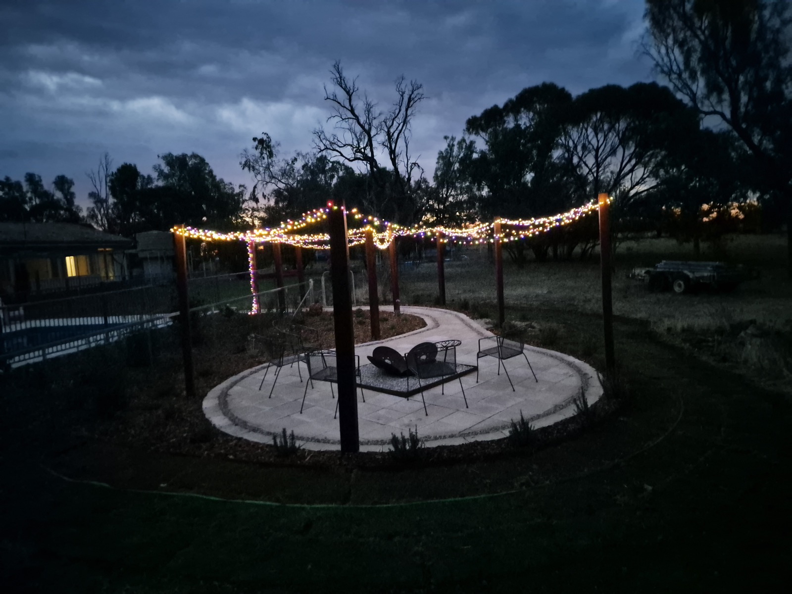 A firepit and paved area at dusk by MR Landscapes