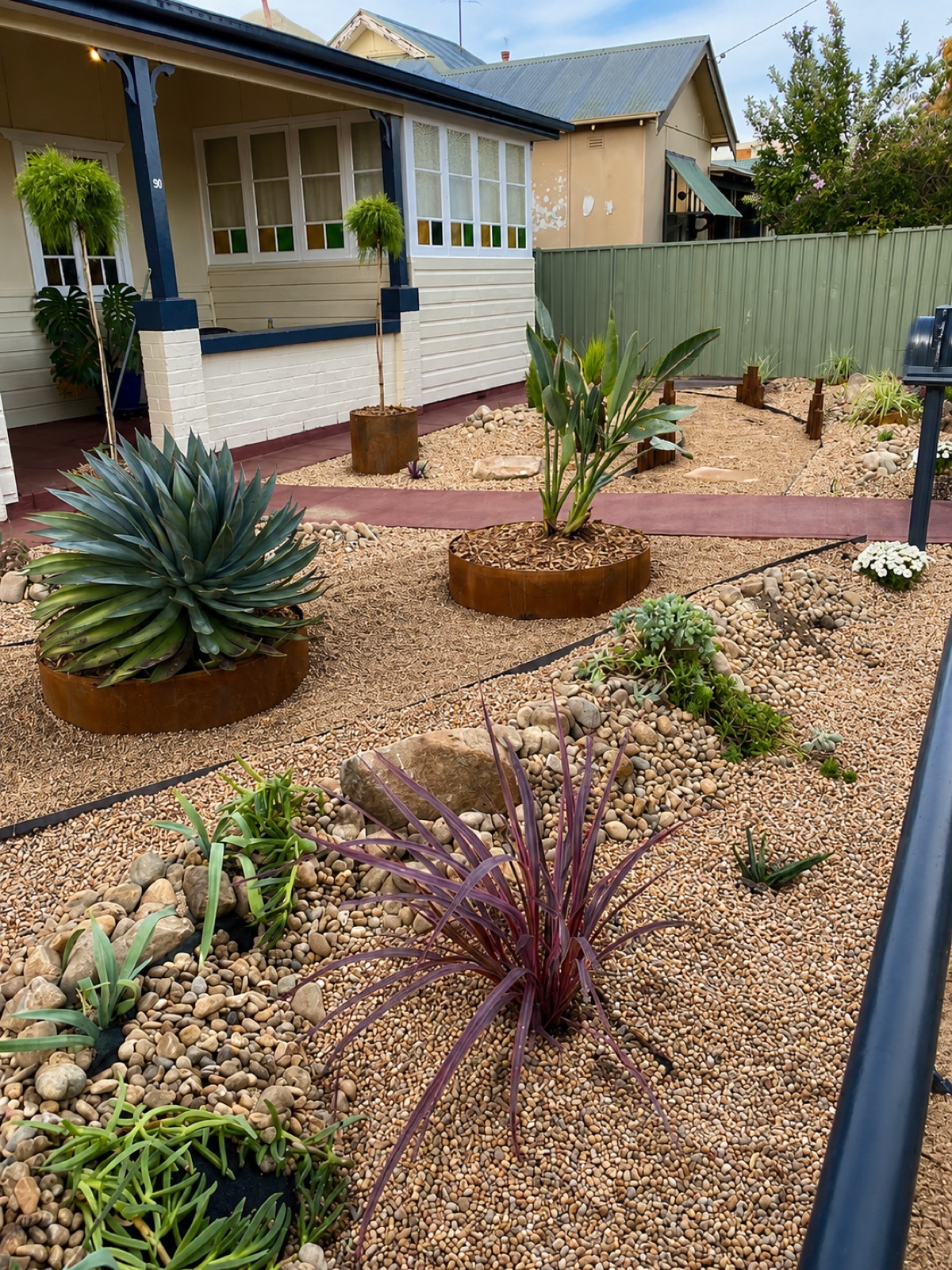 An agave and succulent water-smart front garden designed and built by Matt