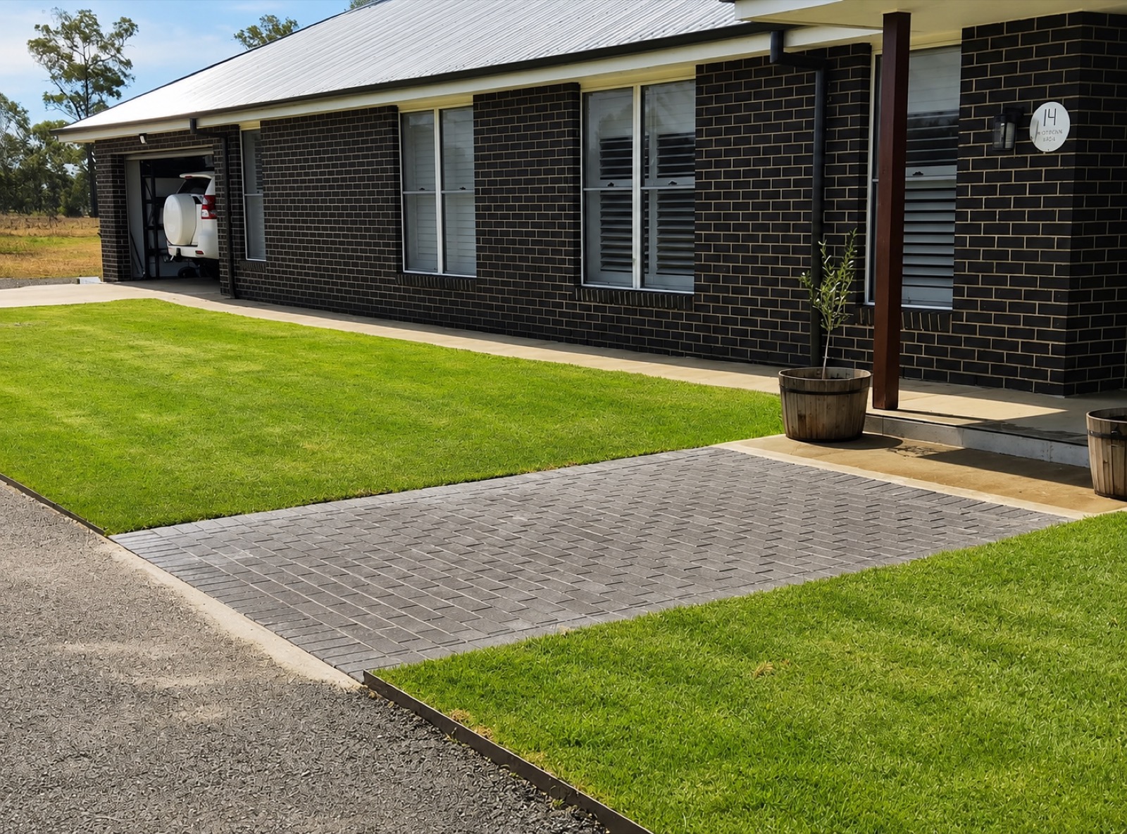 A new lush lawn and brick-paved driveway by MR Landscapes in Dubbo