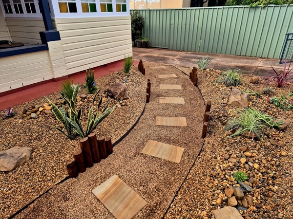 A curved stepping-stone garden design by MR Landscapes