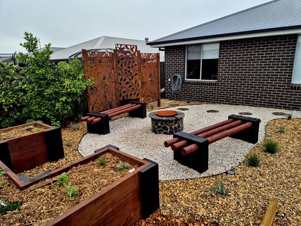 A retaining wall and built-in seating by MR Landscapes