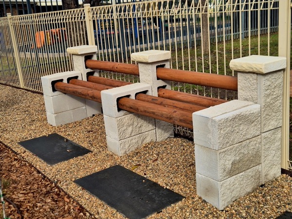 A firepit and bench-seating courtyard by MR Landscapes