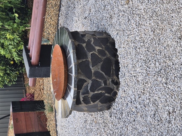 A stone firepit feature built by MR Landscapes