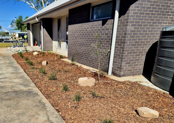 A landscaped garden bed along a home by MR Landscapes