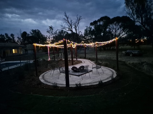 A firepit and paved area at dusk by MR Landscapes