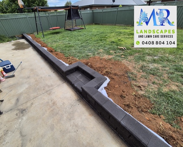A retaining wall and landscaped yard by MR Landscapes