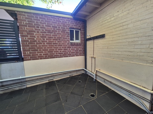 A paved area beside a home by MR Landscapes