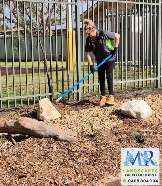 MR Landscapes edging a mulched native garden with sandstone feature rocks in Dubbo