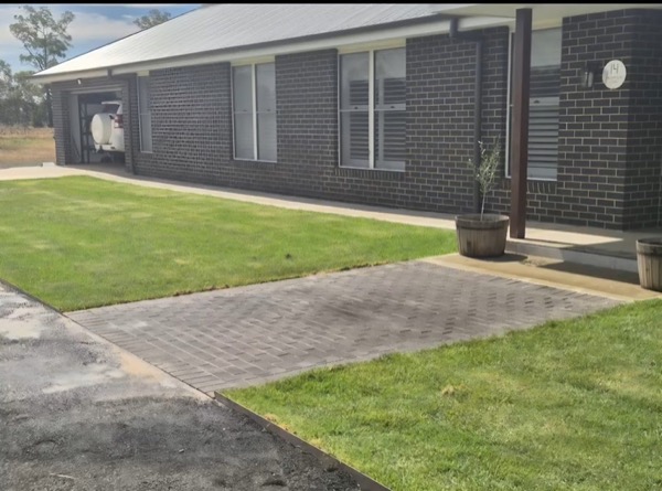 A finished lawn and paved edge by MR Landscapes
